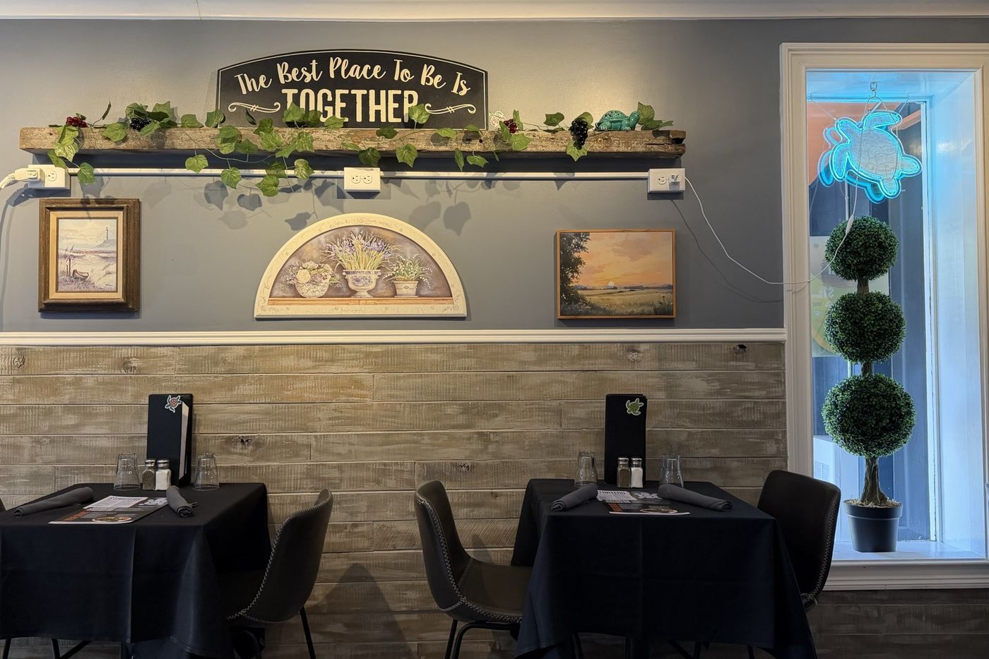 A carved sign reading "The Best Place To Be Is Together" above a reclaimed beam.